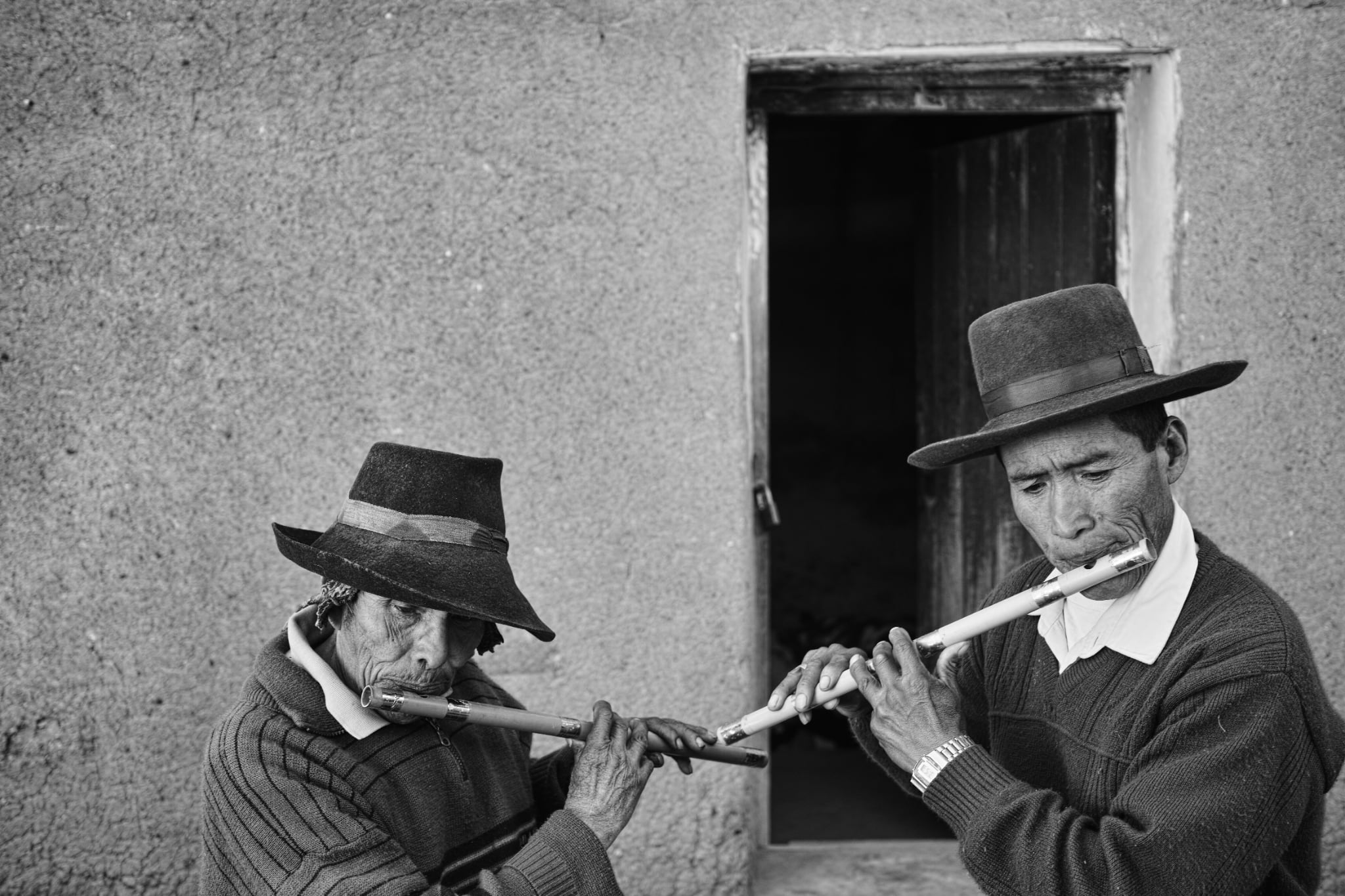 Two people playing flutes