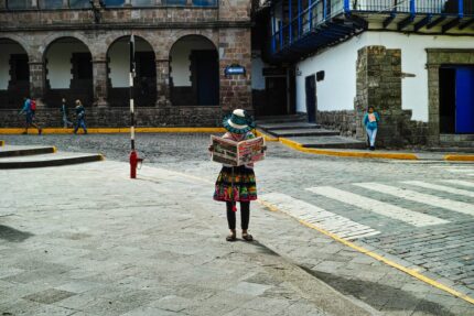 A person reading a book on a sidewalk